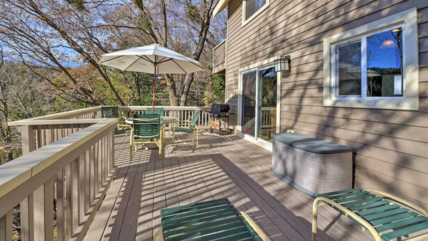 A wooden deck with outdoor furniture, a grill, and a covered seating area. - Mountainside Cabin w/ Deck - 16 Miles to Skiing! (Lake Arrowhead)