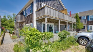 A two-story house with a balcony, a wooden deck, and a garden. - Pool & Beach Access: Coastal Condo in Provincetown (Provincetown)