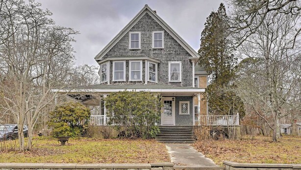 A two-story house with a front porch, a covered entryway, and a small bridge leading to the front door. - Apt on Vineyard Haven Near Nantucket Sound! (Vineyard Haven)