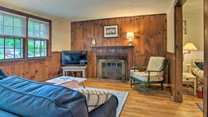 A cozy living room with a fireplace, a television, and a comfortable seating area.