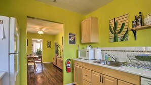 A kitchen with wooden cabinets, a microwave, and a sink. - 'rockview House' 5 Mi to Joshua Tree Nat'l Park! (Joshua Tree)