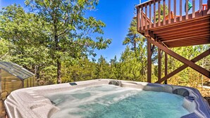 A hot tub surrounded by trees, with a wooden deck above it. - Near Bear Mountain & Big Bear Lake: Gem w/ Hot Tub (Big Bear City)