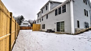 A two-story house with a wooden fence and a snow-covered yard. - Worcester Vacation Rental w/ Ideal Location! (Worcester)