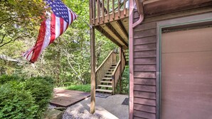 A wooden deck with a staircase leading to a garage door. - Peaceful Nashville Hideaway Near State Parks! (Nashville)