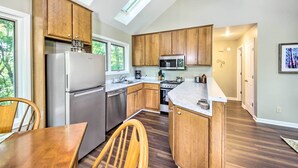 A modern kitchen with wooden cabinets, stainless steel appliances, and a skylight. - Peaceful Nashville Hideaway Near State Parks! (Nashville)