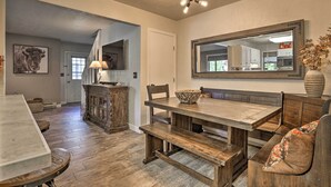 A dining area with a wooden table and benches, a chandelier, and a large mirror above the table. - 2 Mi to Rocky Mtn Nat'l Park: Grand Lake Condo (Grand Lake)