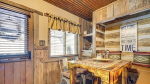A rustic wooden interior with a dining table, chairs, and a 'Welcome' sign. - Jemez Springs Cabin w/ Stunning Mtn Views! (Jemez Springs)