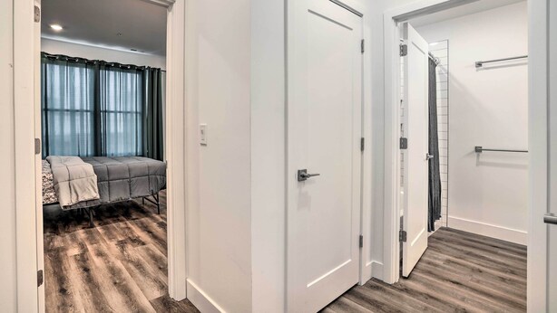 A bedroom with a bed, a bedside table, and a window with curtains. - Trendy Apt w/ Laundry Machines < 3 Mi to Dtwn (Philadelphia)