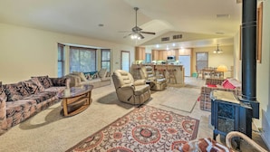 A spacious living room with a sofa, armchairs, a coffee table, and a fireplace. - Twain Harte Home - Perfect for Large Families (Twain Harte)