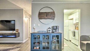 A modern living room with a flat-screen TV, a coffee bar, and a kitchen visible through an open door. - 1/2 Mi to Ocean City Beach! Family-friendly Haven (Ocean City)