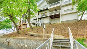 A multi-story building with balconies and a staircase leading up to the entrance. - Water Sports On-site! Lake of the Ozarks Townhome (Lake Ozark)