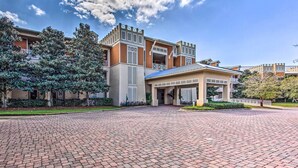 A modern building with a brick-paved entrance, large windows, and a covered walkway. - 30A Retreat w/ Patio & Resort Amenities! (Santa Rosa Beach)