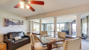 A dining area with a wooden table set for four, surrounded by cushioned chairs. A ceiling fan is visible above the table. - Ski-in/out Granby Ranch Condo w/ Balcony! (Granby)