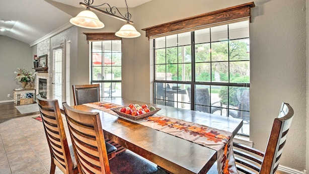 A dining area with a wooden table, chairs, and a fruit basket. - Gainesville Home w/ Outdoor Oasis, 16 Mi to Lake (Gainesville)