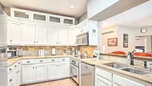 A kitchen with white cabinets, granite countertops, stainless steel appliances, and a tiled backsplash. - Gainesville Home w/ Outdoor Oasis, 16 Mi to Lake (Gainesville)