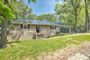 A single-story house with a front porch, a garage, and a stone foundation. - Lake Barkley Waterfront Home w/ Deck & Boat Dock! (Cadiz)