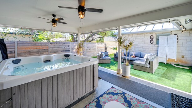 A hot tub in a covered outdoor area with a patio and seating. - Fredericksburg 'regan Cottage' w/ Hot Tub! (Fredericksburg)