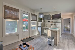 A modern kitchen with a central island, stainless steel appliances, and a pendant light. - 30A Cute Modern Cottage in Seagrove Beach (Santa Rosa Beach)