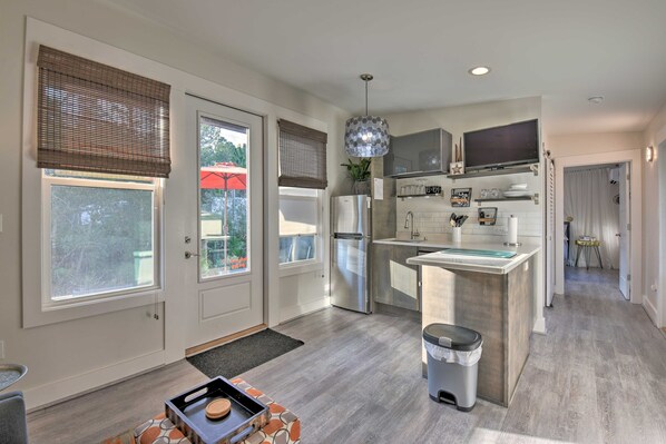 A modern kitchen with a central island, stainless steel appliances, and a pendant light. - 30A Cute Modern Cottage in Seagrove Beach (Santa Rosa Beach)