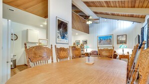 A dining room with a large wooden table and six chairs, a ceiling fan, and framed artwork on the walls. - Mammoth Lakes Condo ~ 5 Mi to Mammoth Mtn! (Mammoth Lakes)