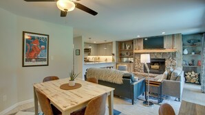 A modern living room with a dining table, sofa, and fireplace. - Renovated Avon Condo 5 Mins to Beaver Creek Resort (Avon)