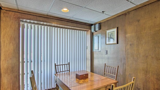 A wooden dining table with a checkered tablecloth, two chairs, and a small wooden box on the table. - Walk to Beaches & Restaurants: Ocean City Condo (Ocean City)