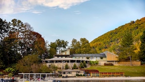 A lakeside lodge with a dock, a covered patio, and a view of the surrounding forest. - Indoor Pool & Golf Course Views: Lake Lure Condo! (Lake Lure)