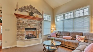 A living room with a stone fireplace, a sofa, and a glass coffee table. - Townhome w/ Grill < 1 Mi to Big Boulder Mountain (Lake Harmony)
