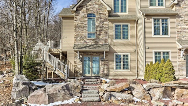 A multi-story house with a stone facade, a front porch, and a staircase leading to a deck. - Townhome w/ Grill < 1 Mi to Big Boulder Mountain (Lake Harmony)