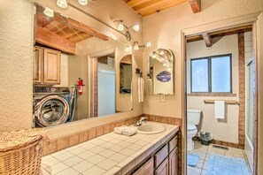A bathroom with a large mirror, a sink, a washing machine, and a window. - 'zen Forest Mountain Retreat' Tahoe Home W/hot Tub (South Lake Tahoe)