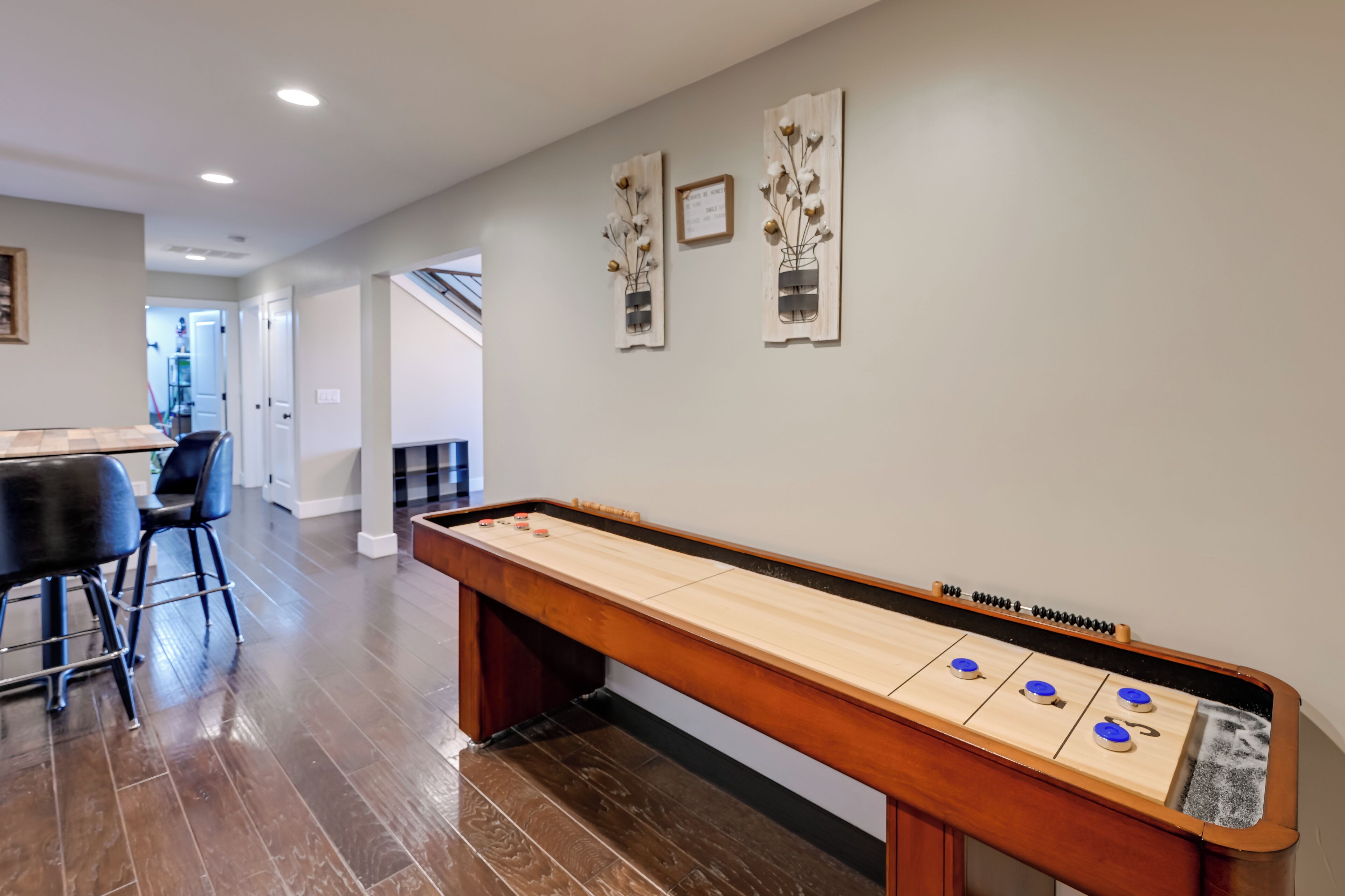 Una habitación amplia con mesa de fútbol, zona de bar y comedor.