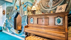 A grand piano with a decorative backdrop, a mirror, and a sign with the word "Be". - Mtn-view SLC Apt w/ Patio Near Downtown (Salt Lake City)