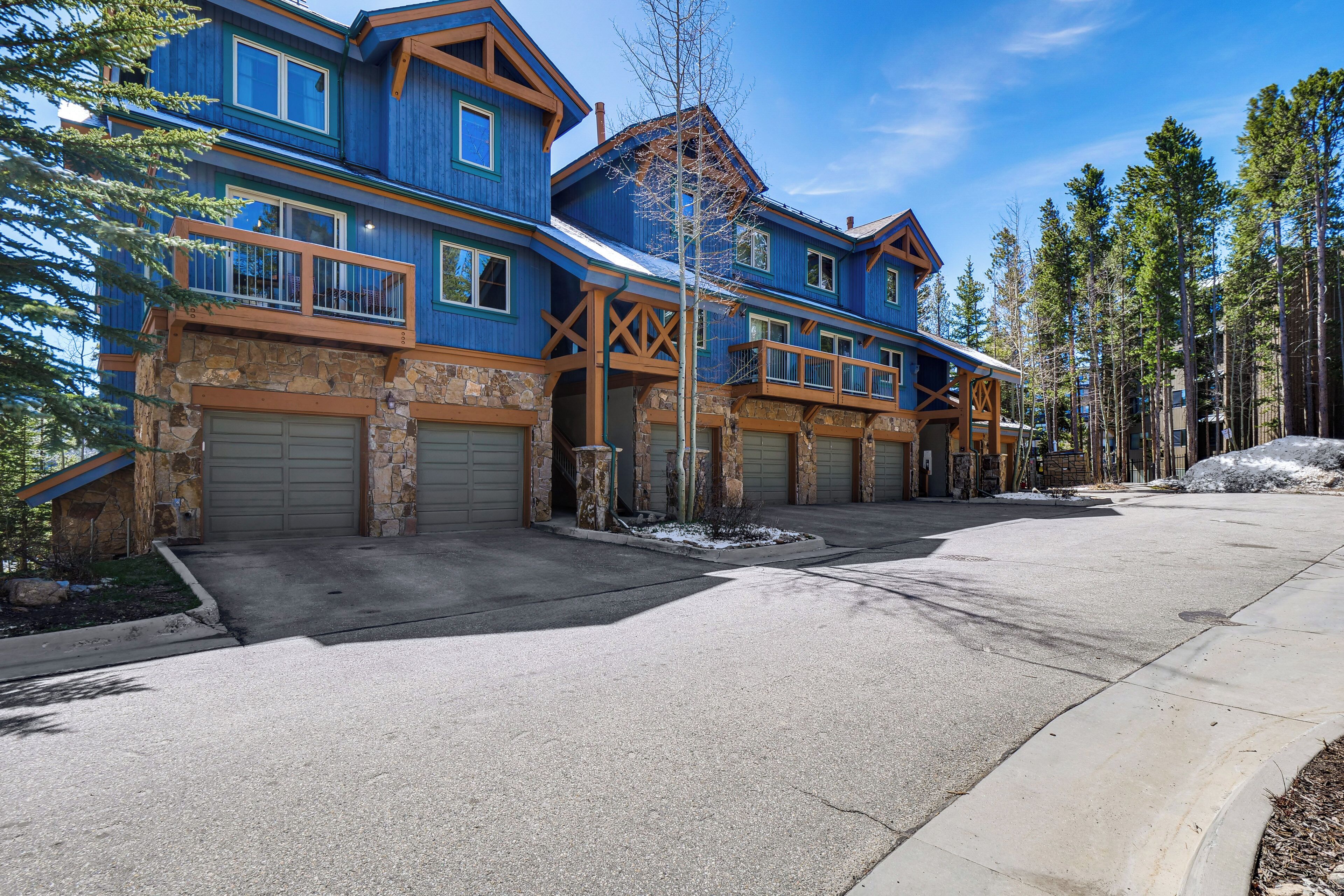A large, multi-story building with a stone facade and multiple garage doors.