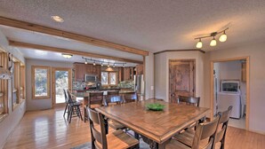 A spacious kitchen with wooden cabinets, a large dining table, and a built-in oven. - ~ 1 Mi to Downtown: Buena Vista Riverfront Escape! (Buena Vista)