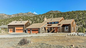 A two-story house with a garage, a front porch, and a stone foundation. - ~ 1 Mi to Downtown: Buena Vista Riverfront Escape! (Buena Vista)