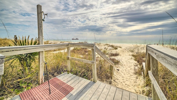 A wooden boardwalk leading to a beach with a sandy path and sparse vegetation. - Beachfront PCB Studio: Pool, Patio & Deck Access! (Panama City Beach)