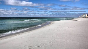 A beach with a clear sky and a distant pier. - Panama City Beach Studio w/ Pool & Beach Access (Panama City Beach)