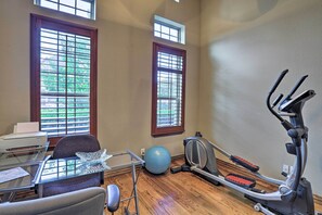 A home office with a desk, chair, printer, and exercise equipment. - Chic Family-friendly Home in Irving w/ Yard! (Irving)