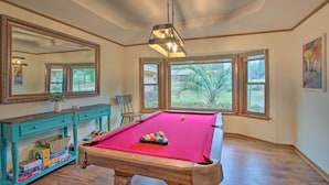 A pool table in a room with large windows, a mirror, and a wooden floor. - Roomy Texas Lake Retreat w/ Private Boat Ramp (Frankston)