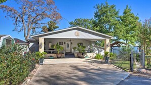 A house with a covered porch, a front door, and a small staircase leading up to the entrance. - Dock & Fire Pit: Waterfront Cedar Creek Lake Home (Kemp)