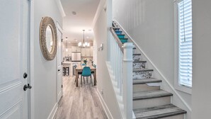 A hallway leading to a dining area with a staircase and a view of the kitchen. - 4 Mi to Beach: Family-friendly Hilton Head Retreat (Hilton Head Island)