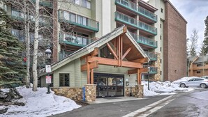 A multi-story building with a covered entrance and stone accents. - Walk to Main St: Ski-in/ski-out Breckenridge Condo (Breckenridge)