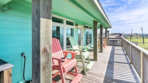 A wooden deck with Adirondack chairs and a view of the ocean. - Surfside Beach Home w/ Views, Steps to Shore! (Freeport)