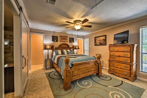 Enjoy a comfortable stay in this well-appointed room featuring a large bed, dresser, and TV.
