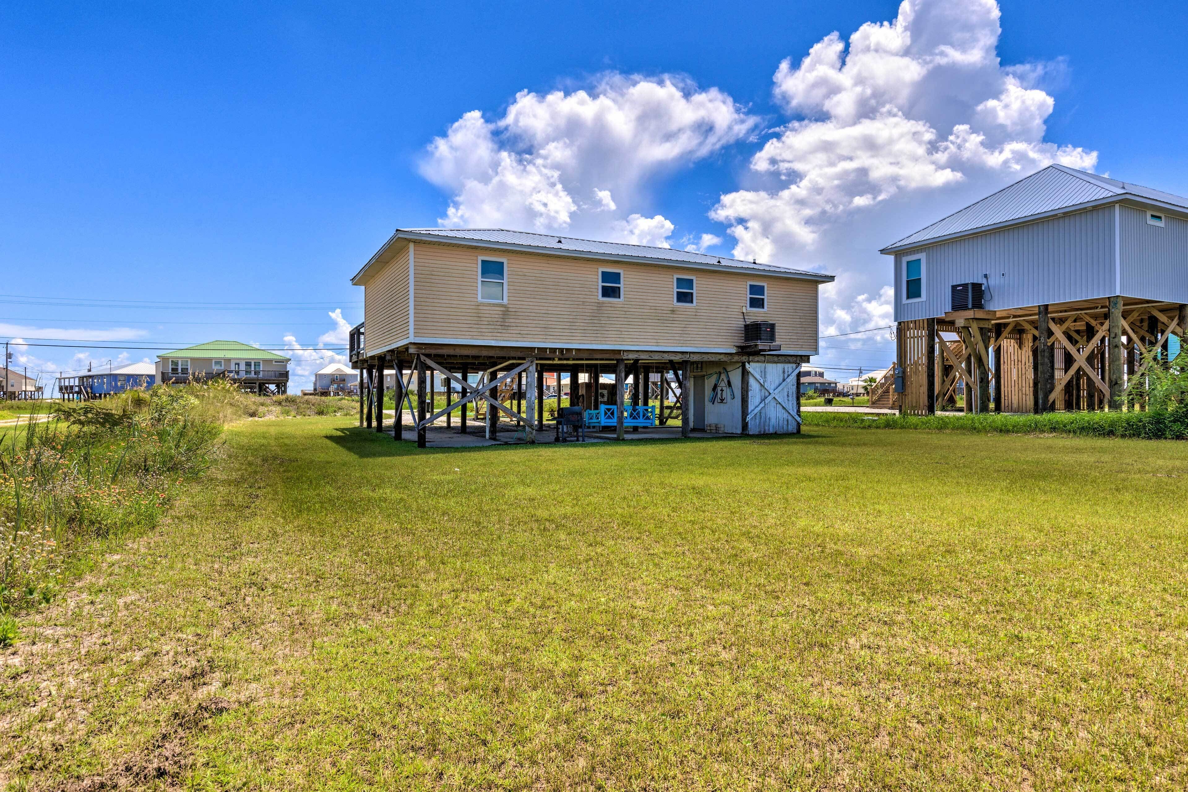 A two-story house with a covered porch and a small deck.