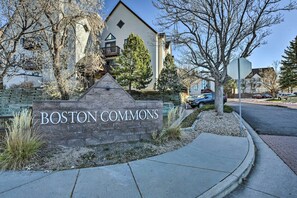 A sign for 'BOSTON COMMONS' with a stone wall and a triangular stone structure in front. - Greenwood Village Condo w/ Pool Access! (Englewood)