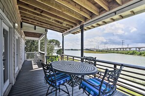Enjoy a serene outdoor space with a deck overlooking the water, perfect for relaxing with a meal at the metal-framed table.