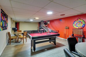 A pool table with a red felt surface, a dartboard, and a staircase leading to an upper level. - 'hidden Paradise' on 5 Acres w/ Hot Tub & Deck! (Florissant)