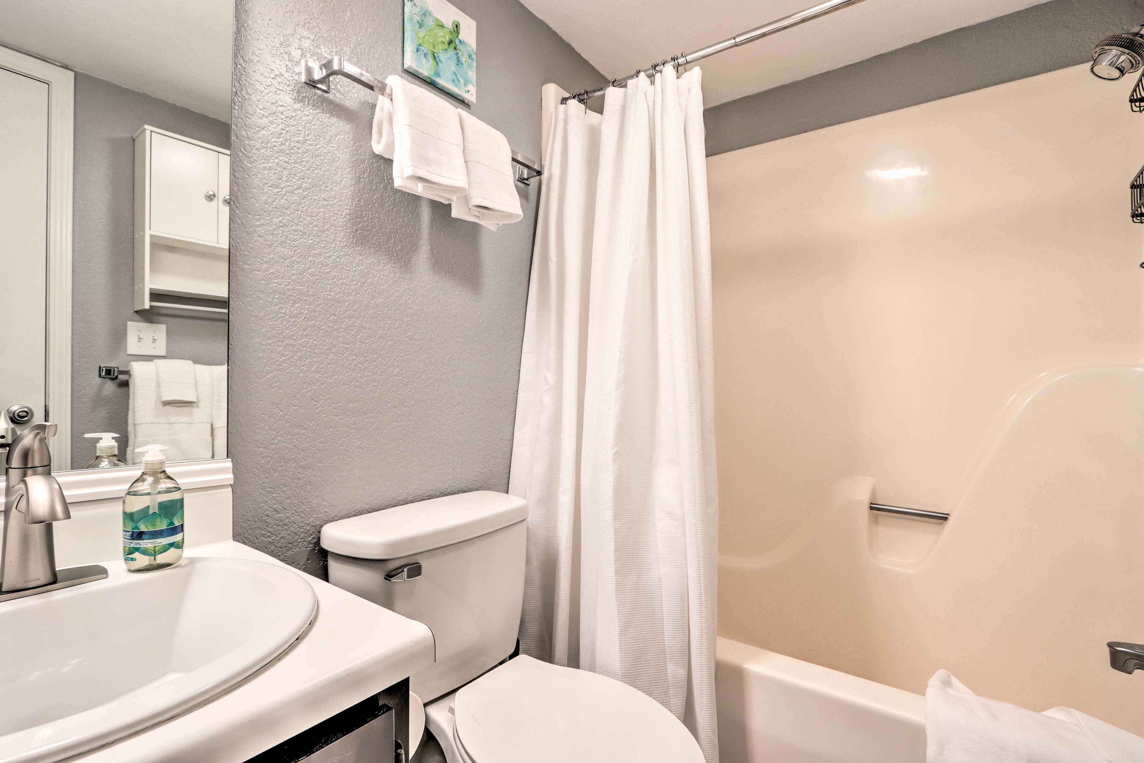 A bathroom with a sink, toilet, and shower.