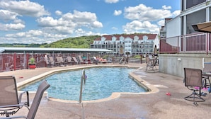 A pool area with lounge chairs and a pool. - 'the Lake Escape w/ Balcony & Pool Access! (Camdenton)